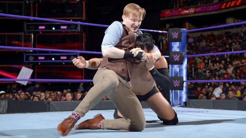 Jack Gallagher locked in the headlock on Itami during their match
