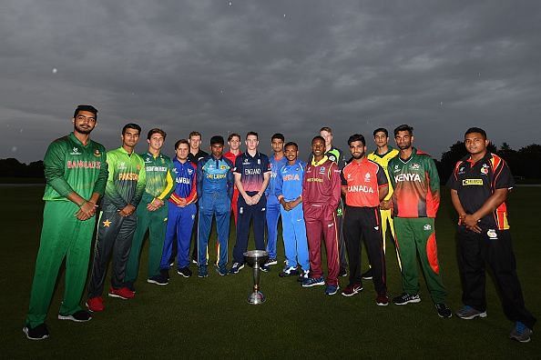 Team captains pose with the ICC under-19 World Cup trophy during the opening ceremony