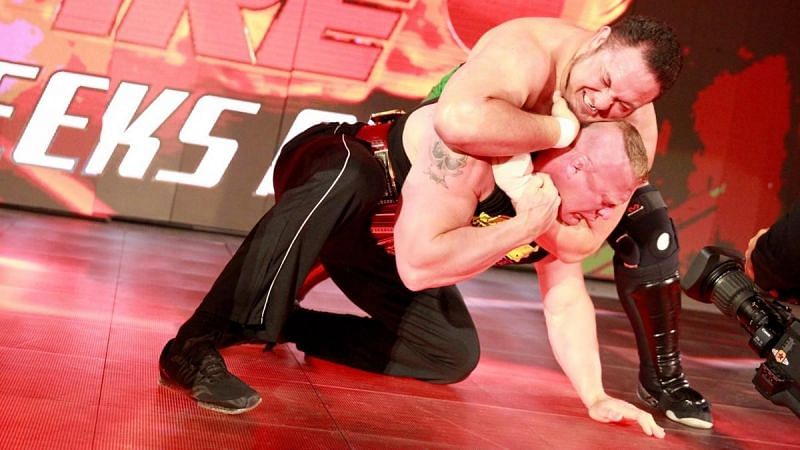 Samoa Joe traps Brock Lesnar in an unbreakable Coquina ClutchEnter caption