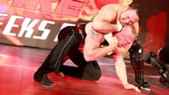 Samoa Joe traps Brock Lesnar in an unbreakable Coquina ClutchEnter caption