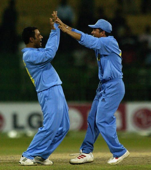 Virender Sehwag and Sachin Tendulkar of India celebrate a wicket