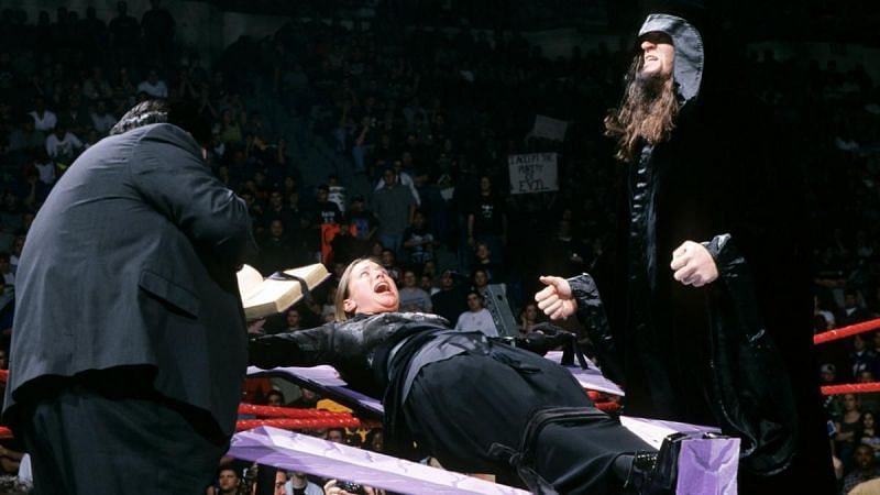 Undertaker crucifying a young Stephanie McMahon