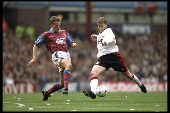 Gareth Southgate of Aston Villa (left) goes for the ball with Ole Gunnar Solksjaer
