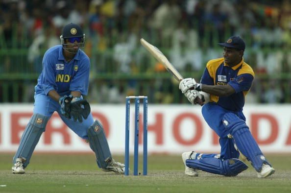 Sanath Jayasuriya of Sri Lanka on his way to a half century watched by Rahul Dravid of India