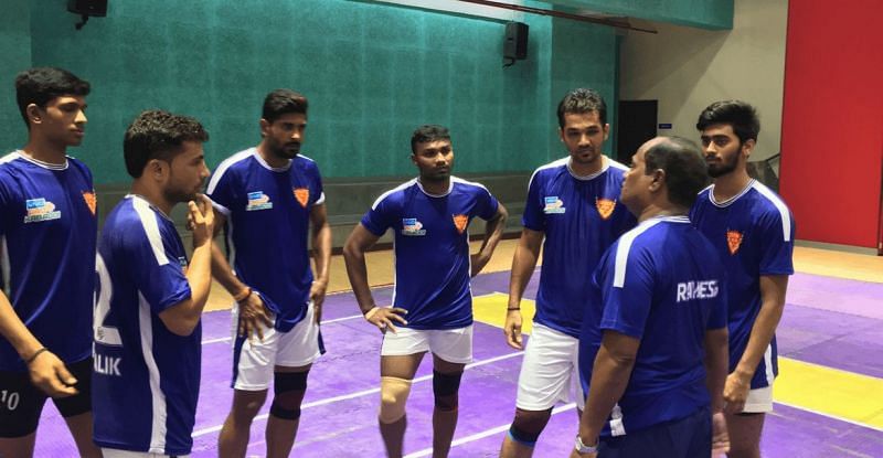 Ravi Dalal and other Dabang Delhi players listening to their words of their coach.