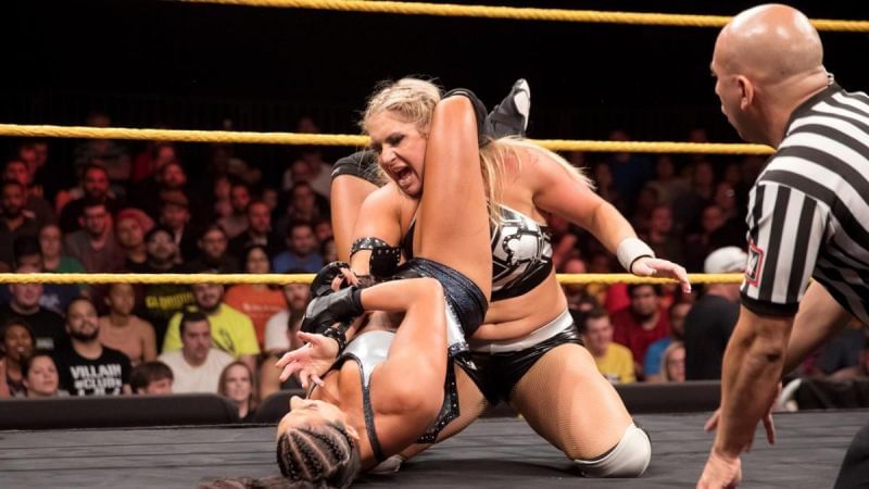 Sonya Deville applying a triangle armbar