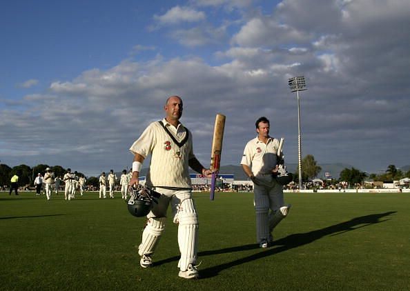 Darren Lehmann and Steve Waugh of Australia leave the field at the close of play