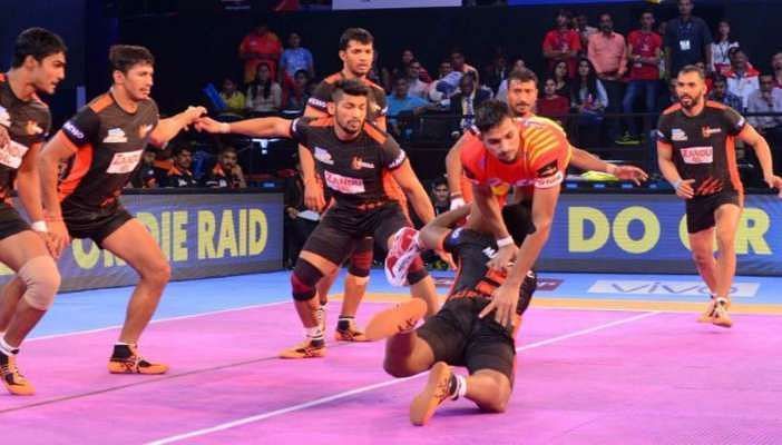 Nitin Madane watches as Surinder Singh attempts a tackle.