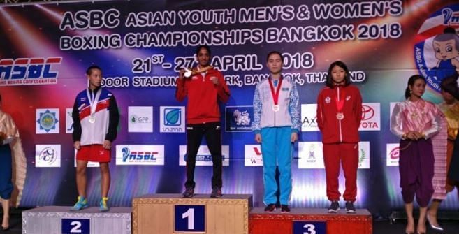Nitu Ghanghas with her gold medal on the podium.