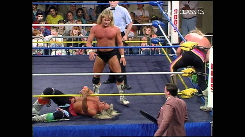 Stan Lane of the Midnight Express has Ricky Morton of the Rock and Roll Express at a disadvantage.