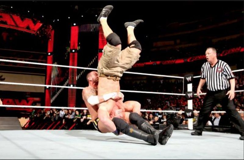 CM Punk uses a Piledriver on John Cena.