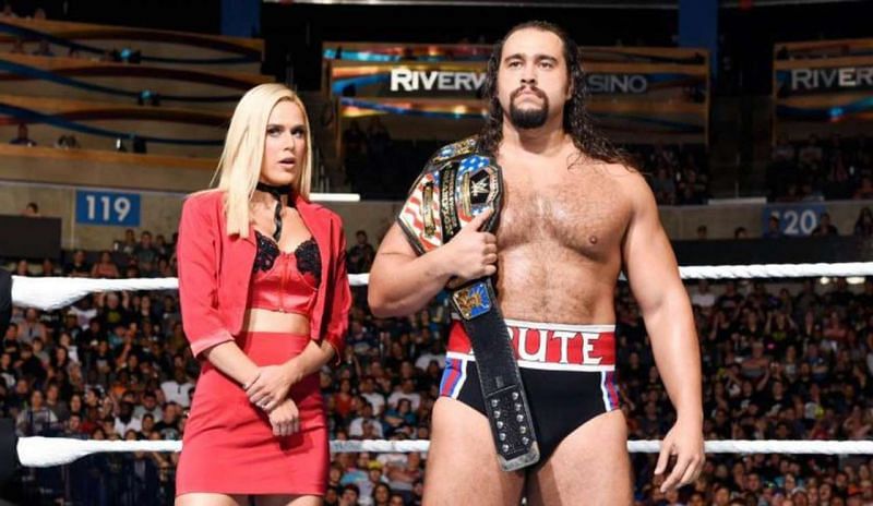 Rusev as champion with manager, and real-life spouse Lana.