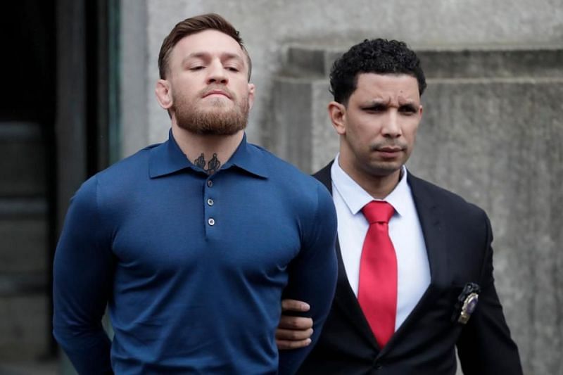 Conor McGregor is led out of a New York Police station in handcuffs.