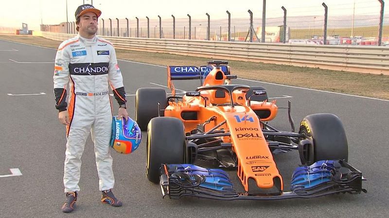 Fernando Alonso posing with his car 2018