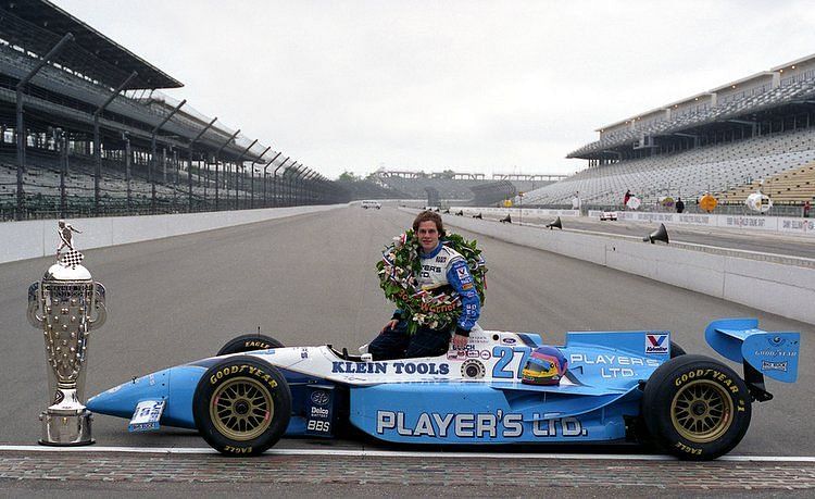 Jacques Villeneuve posing with his 1995 Indy 500 trophy