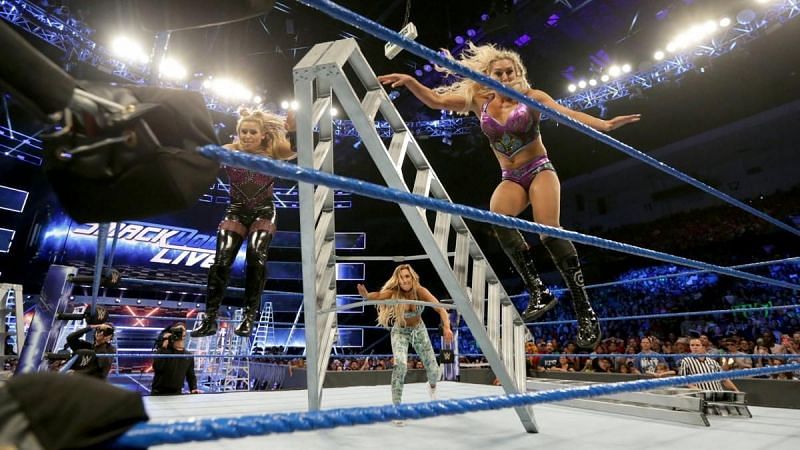 Carmella pushes Charlotte and Natalya off the ladder