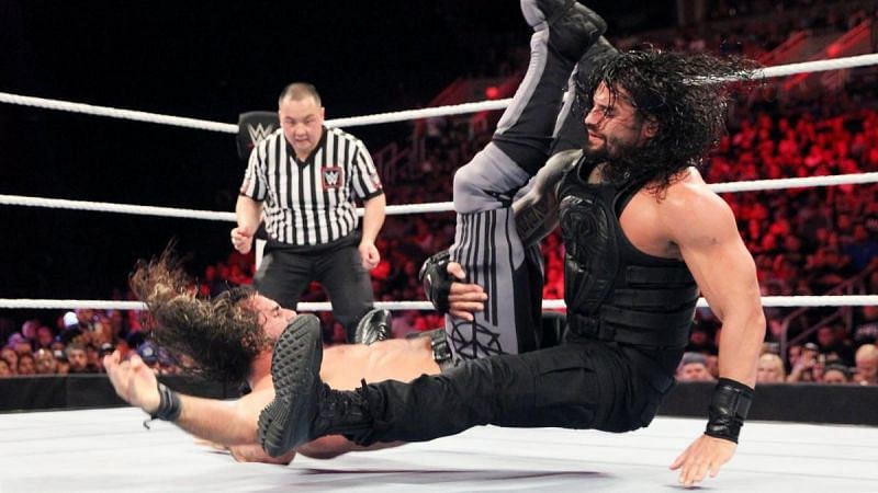 Roman Reigns hits Seth Rollins with a Powerbomb