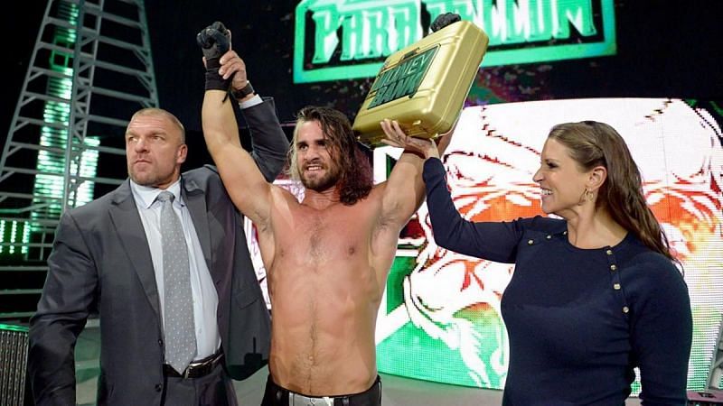 Seth Rollins, Triple H and Stephanie McMahon celebrate