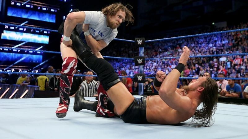 Daniel Bryan puts pressure on the leg of Big Cass