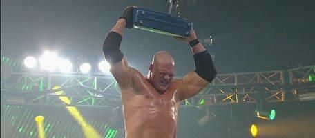 Kane holds the briefcase after his victory