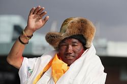 Record Everest climber returns, already planning next trip