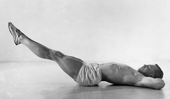 Man doing breathing exercises, expiration / breathing out with lifted legs- Photographer: Fotografisches Atelier Ullstein- 1932Vintage property of ullstein bild