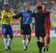 Referee Kim Young Joo gives a red card to Turkey's