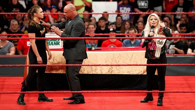 Ronda Rousey was held back by Kurt Angle while Alexa Bliss insulted her