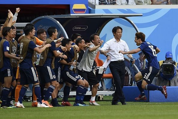 Akira Nishino celebrating the winning goal with his players