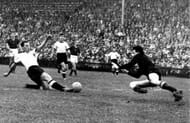 1954 World Cup Final. Bern,Switzerland. 4th July 1954. West Germany.3.v Hungary.2. West Germany's Max Morlock stretches to beat Hungary goalkeeper Gyula Grosics and score their first goal.