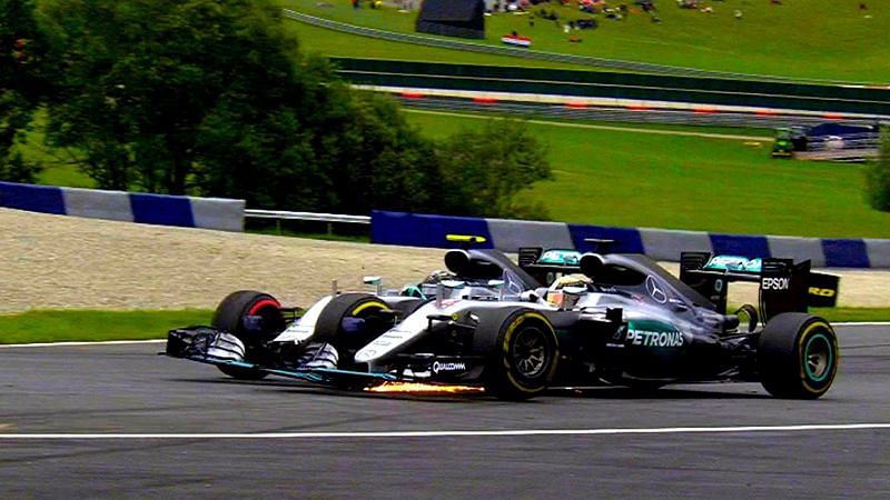 Lewis Hamilton and Nico Rosberg go wheel to wheel on turn 2