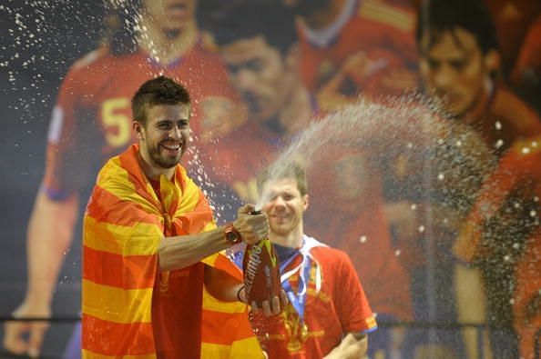 Spain&#039;s defender Gerard Pique sprays cha