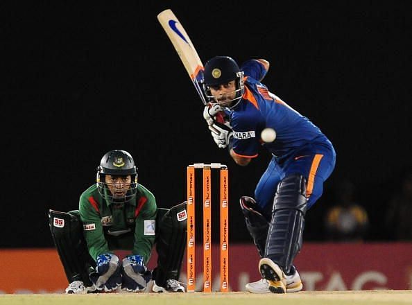 Indian cricketer Virat Kohli (R) is watc