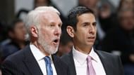 Borrego standing beside Popovich by the bench