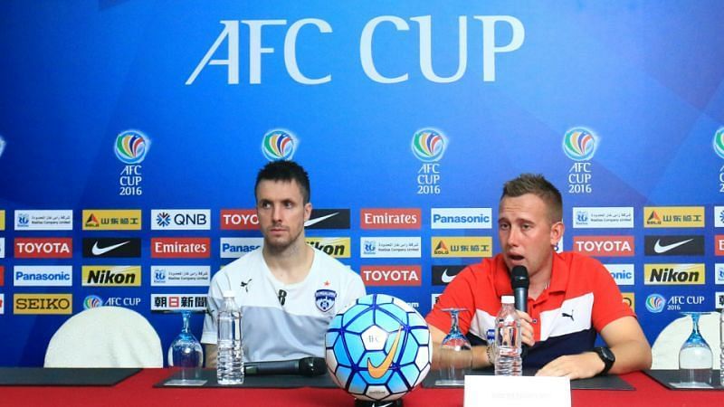 Michael Collins (left) attending a pre-match press conference for Bengaluru FC 