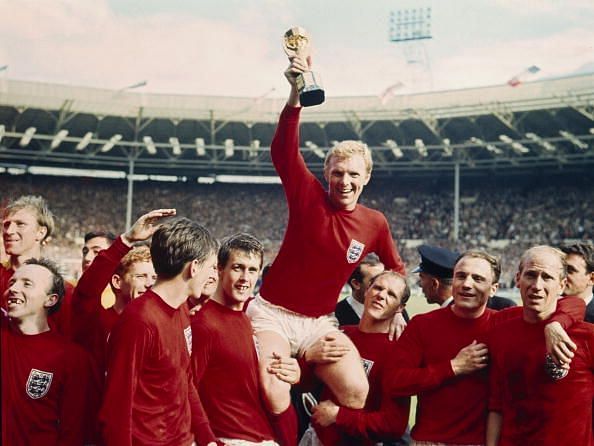 Sport Football. pic: 30th July 1966. 1966 World Cup Final at Wembley. England 4 v West Germany 2 a.e.t. England captain Bobby Moore holds aloft the World Cup (Jules Rimet trophy) as the team gather around to celebrate.