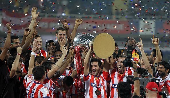 Atletico De Kolkata (now ATK) players celebrate with the trophy after their victory over Kerala Blasters in the final match of ISL 2014