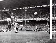 World Cup Finals, 1966. Liverpool, England. 19th July, 1966. Portugal 3 v Brazil 1. Eusebio of Portugal (L) beats Brazil's Orlando to the ball to head home his side's second goal past Brazilian goalkeeper Manga during their Group Three match