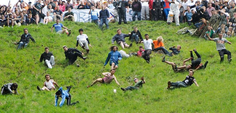 Cheese Rolling: Contestants rolls down a hill to catch the cheese. First person to cross the finish line is the winner.