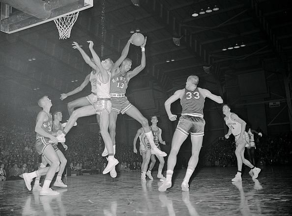 Wilt Chamberlain Leaping over Others