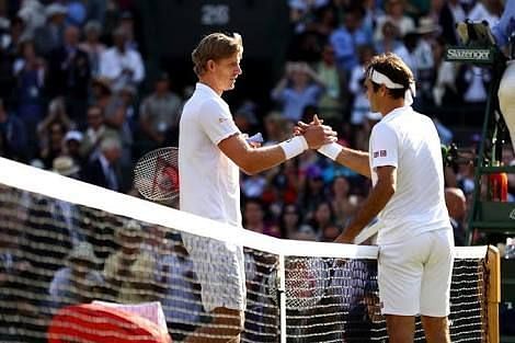 Kevin Anderson shakes hands with Roger Federer after an exhaustive encounter