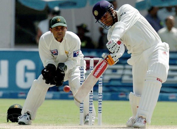 Indian batsman Virender Sehwag (R) hits