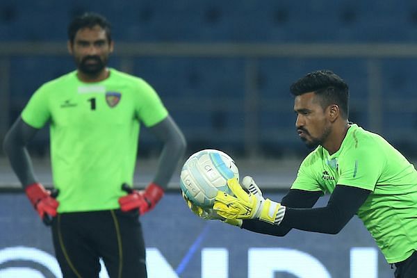 Pawan Kumar makes a save during warm-up as Karanjit Singh looks on