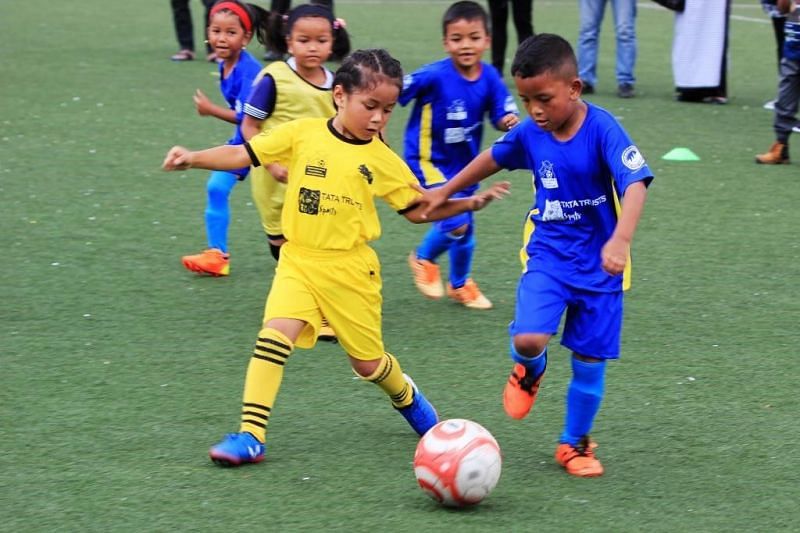 Energetic players from the Under 8 category show-off their dribbling skills during a match