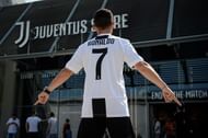 A supporter of Juventus FC poses with Cristiano Ronaldo's...