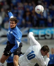 Estonia's Andres Oper (L) fights for the