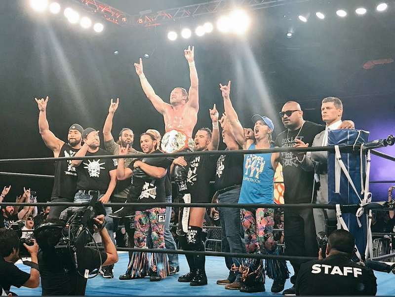 Omega celebrating his US Title win with the entire Bullet Club 