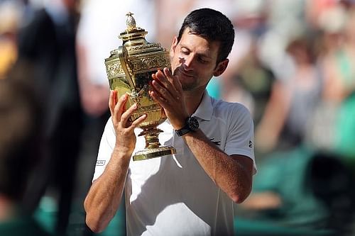 Novak Djokovic celebrates winning Wimbledon for the fourth time