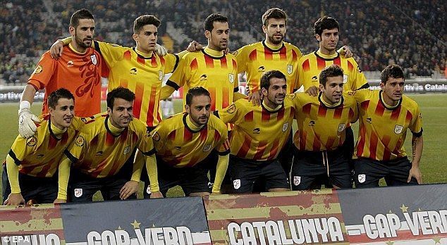 Pique and Fabregas playing a friendly match for Catalonia.