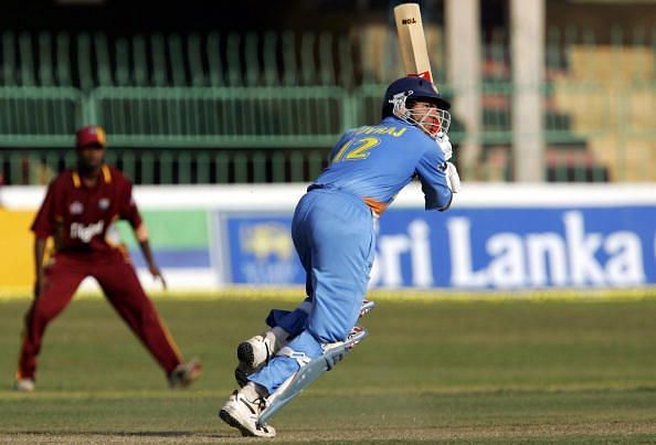 Indian cricketer Yuvraj Singh (R) is wat
